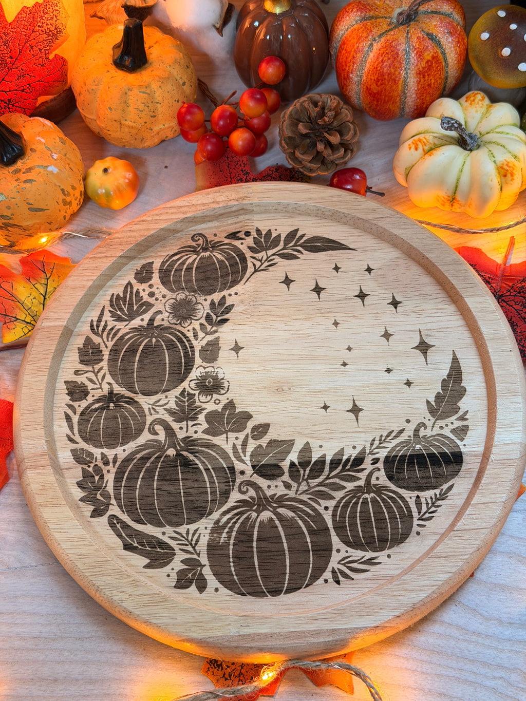 Lune d'Automne, plateau rond en bois gravé au laser d'un croissant de lune orné de citrouilles et de feuillage, entouré de citrouilles décoratives et guirlande lumineuse - L'Atelier du Moulin
